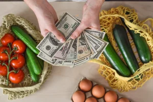 Woman realizing the how inflation has increase interest rates when checking out at a grocery store